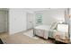 Bright bedroom with wood floors, light walls, ceiling fan and large window at 9334 New Towne Dr, Matthews, NC 28105