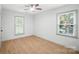 Bedroom featuring wood floors, two windows and ceiling fan at 9334 New Towne Dr, Matthews, NC 28105