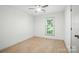 Bedroom with wood floors, ceiling fan, and a bright window at 9334 New Towne Dr, Matthews, NC 28105
