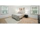 A well lit modern bedroom featuring a queen bed and hardwood floors at 9334 New Towne Dr, Matthews, NC 28105