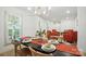 A modern dining room with a chandelier, seating for six, and hardwood floors at 9334 New Towne Dr, Matthews, NC 28105