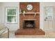Close-up of a classic brick fireplace with a decorative mantel, perfect for cozy evenings at 9334 New Towne Dr, Matthews, NC 28105