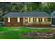 Charming single-story home with a welcoming front porch, brick accents, and lush landscaping at 9334 New Towne Dr, Matthews, NC 28105