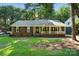 Charming brick and siding home featuring a cozy front porch and well-maintained lawn at 9334 New Towne Dr, Matthews, NC 28105
