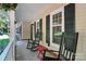 Cozy front porch with rocking chairs, decorative flowers, and views of the surrounding neighborhood at 9334 New Towne Dr, Matthews, NC 28105