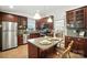 A spacious kitchen featuring stainless steel appliances, granite countertops and an island with seating at 9334 New Towne Dr, Matthews, NC 28105
