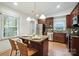 A spacious kitchen featuring stainless steel appliances, granite countertops and an island with seating at 9334 New Towne Dr, Matthews, NC 28105