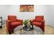 A cozy living room featuring comfortable chairs, hardwood floors, and bright natural lighting at 9334 New Towne Dr, Matthews, NC 28105