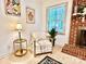 Cozy living room featuring chair, decor, a fireplace with brick surround, and natural light at 9334 New Towne Dr, Matthews, NC 28105