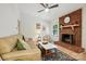Inviting living room with a brick fireplace, comfortable seating, and bright natural light at 9334 New Towne Dr, Matthews, NC 28105