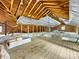 Spacious attic with exposed wood beams, insulation, and natural light from side windows at 112 8Th Nw Ave, Hickory, NC 28601