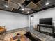 This finished basement includes a ceiling fan, TV and a decorative rug with an animal skin on top at 112 8Th Nw Ave, Hickory, NC 28601