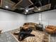 Finished basement with furniture, and textured area rug, and decorative ceiling detail at 112 8Th Nw Ave, Hickory, NC 28601
