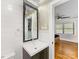 This bathroom features a vanity with a dark wood cabinet, a large mirror, and shiplap walls at 112 8Th Nw Ave, Hickory, NC 28601