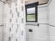 This bathroom features a shower with a patterned shower curtain and a window at 112 8Th Nw Ave, Hickory, NC 28601