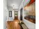 Bright entryway featuring hardwood floors, elegant lighting fixtures, decorative mirror, and a wooden door with glass panel at 112 8Th Nw Ave, Hickory, NC 28601