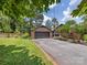 Traditional brick home with a black roof, a spacious driveway, and a well-manicured lawn at 112 8Th Nw Ave, Hickory, NC 28601