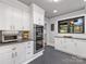 Modern kitchen featuring white cabinetry, stainless steel appliances, updated fixtures, and gray tile flooring at 112 8Th Nw Ave, Hickory, NC 28601