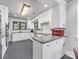 Bright kitchen featuring white cabinets, granite countertops, stainless steel appliances, and gray tile flooring at 112 8Th Nw Ave, Hickory, NC 28601
