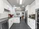 Well lit kitchen with stainless steel appliances, granite countertops, and white cabinetry at 112 8Th Nw Ave, Hickory, NC 28601
