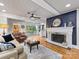 Cozy living room with hardwood floors, a fireplace, and access to outdoor patio seating at 112 8Th Nw Ave, Hickory, NC 28601