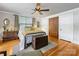 Bright main bedroom with hardwood floors, two windows, and a metal bed frame at 112 8Th Nw Ave, Hickory, NC 28601