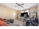 Cozy bonus room features neutral carpeting, a ceiling fan, and a comfortable couch at 1216 Catawba Run, Lowell, NC 28098