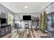 Unique bonus room features wood floors, a beauty station, a treadmill, and a TV at 1216 Catawba Run, Lowell, NC 28098