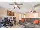 Open concept bonus room with carpeting, ceiling fan, and a comfortable gray couch at 1216 Catawba Run, Lowell, NC 28098