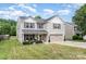 Well-maintained two-story home with a lush green lawn and attached two-car garage at 1216 Catawba Run, Lowell, NC 28098