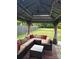 Relaxing gazebo with comfortable seating, string lights, and a well-manicured lawn at 1216 Catawba Run, Lowell, NC 28098