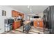 Functional kitchen with black appliances, wood cabinets, and an eat-in bar at 1216 Catawba Run, Lowell, NC 28098