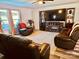 Cozy living room with a fireplace, entertainment center, and comfortable leather seating at 1216 Catawba Run, Lowell, NC 28098