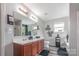 Main bathroom with a double vanity, tiled floors, and a large framed mirror at 1216 Catawba Run, Lowell, NC 28098