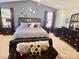 Serene main bedroom with a vaulted ceiling, decorative mirrors, and dark wood furniture at 1216 Catawba Run, Lowell, NC 28098