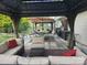 Inviting outdoor patio featuring comfortable seating, dining area, and lush greenery at 1216 Catawba Run, Lowell, NC 28098