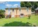 Backyard view of home showing the staircase, grass, and air conditioner at 127 Bristol Rd, Statesville, NC 28677