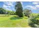 Large, well-maintained backyard with mature trees and fenced garden area at 127 Bristol Rd, Statesville, NC 28677