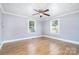 Empty bedroom with hardwood floors, ceiling fan, and natural light from two windows at 127 Bristol Rd, Statesville, NC 28677