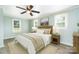 Comfortable bedroom featuring a ceiling fan, natural light from the windows, and stylish decor at 127 Bristol Rd, Statesville, NC 28677
