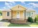 Charming single-story home featuring a cozy front porch, classic design, and well-maintained landscaping at 127 Bristol Rd, Statesville, NC 28677