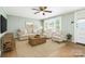 Comfortable living room featuring neutral tones, a ceiling fan, and natural light from a large window at 127 Bristol Rd, Statesville, NC 28677
