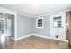 Unfurnished Living Room featuring hardwood floors, window and paneled walls at 127 Bristol Rd, Statesville, NC 28677