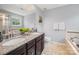 Bathroom featuring double sinks with granite countertops and a large mirror at 1307 Farm Branch Sw Dr, Concord, NC 28027