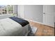 Bedroom featuring hardwood floors and a sunlit window at 1307 Farm Branch Sw Dr, Concord, NC 28027