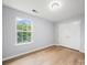 Bedroom featuring hardwood floors, closet, and natural light at 1307 Farm Branch Sw Dr, Concord, NC 28027