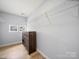 Walk-in closet with shelving and custom wood cabinets at 1307 Farm Branch Sw Dr, Concord, NC 28027