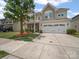 Charming two-story home with a well-manicured lawn, two car garage, and lovely stone accents at 1307 Farm Branch Sw Dr, Concord, NC 28027