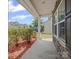 A view from the front porch featuring shrubbery and wood mulch and a house in the distance at 1307 Farm Branch Sw Dr, Concord, NC 28027