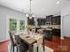 Open concept kitchen with an island, dark cabinets and stainless steel appliances at 1307 Farm Branch Sw Dr, Concord, NC 28027